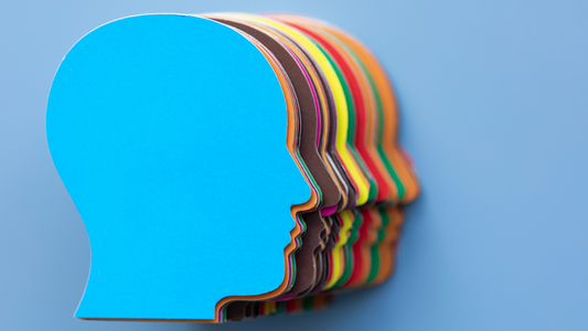Colorful paper cutouts of human heads stacked together – diversity and inclusion in mental health